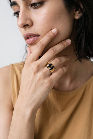 open-band ring featuring twin glossy obsidian-look accents